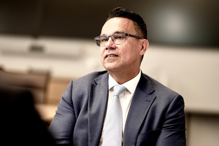 AUSTRAC CEO Brendan Thomas wearing a suit.