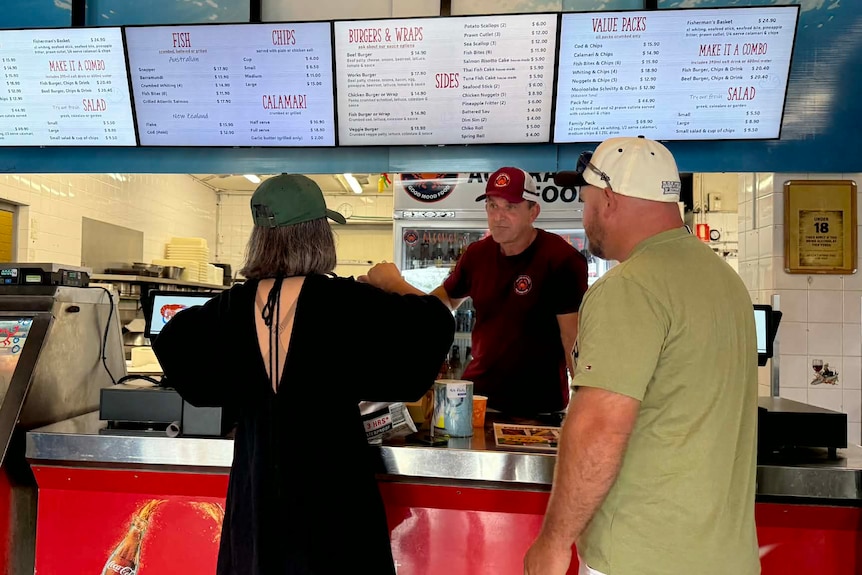 Man at counter with customers