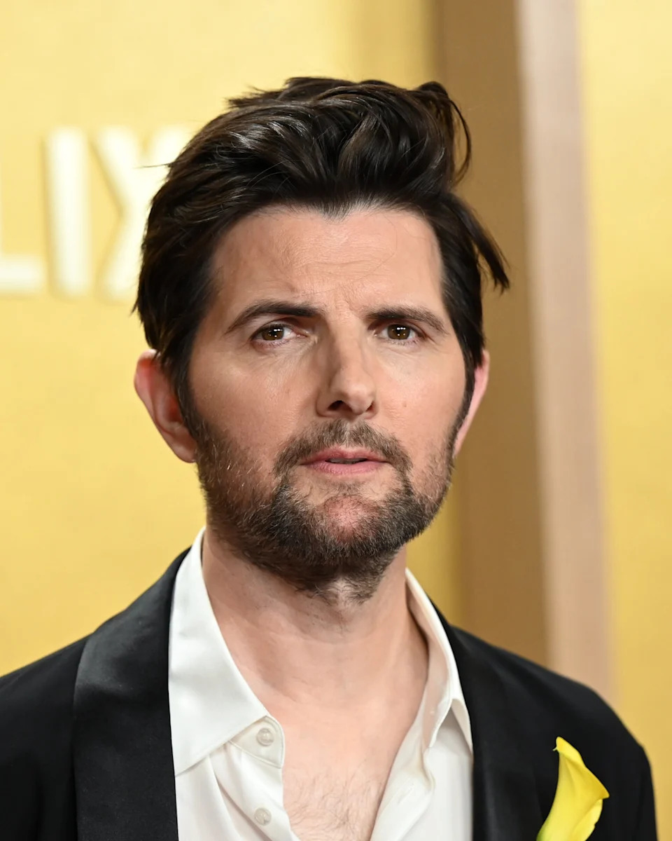 Adam Scott in a shirt and blazer with a flower on the red carpet