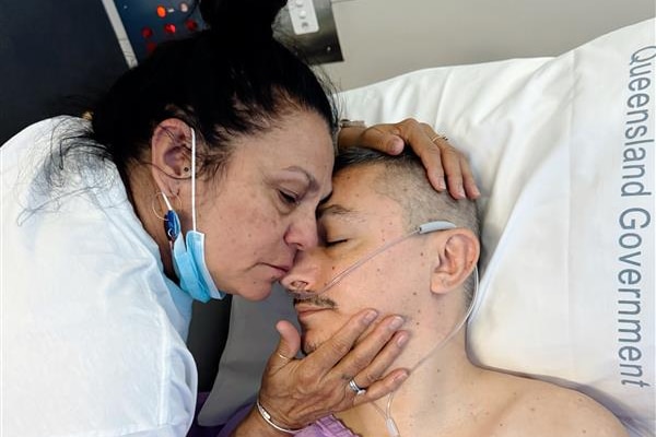 Sajarn's mother Michelle comforts him after surgery in the Princess Alexandra Hospital in Brisbane.