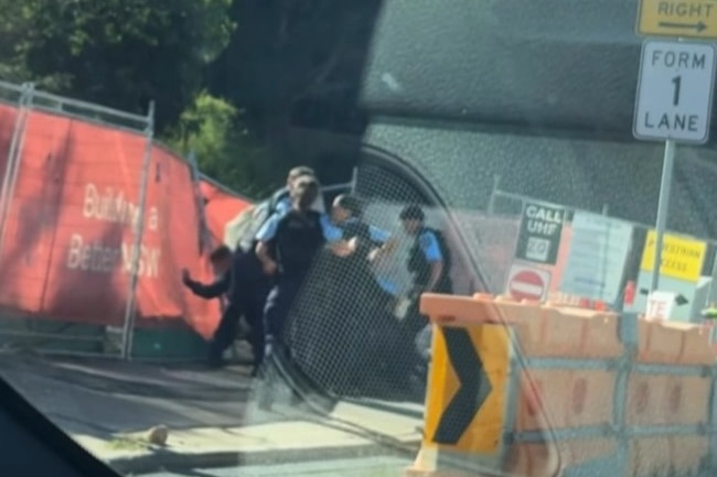 Police arresting a man after an alleged pursuit.