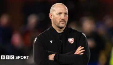 George Skivington stands with his arms folded across his chest