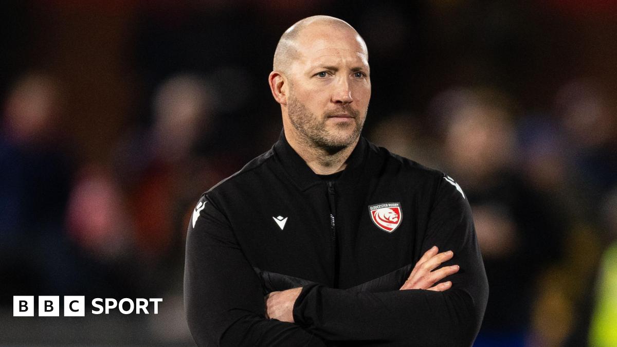 George Skivington stands with his arms folded across his chest