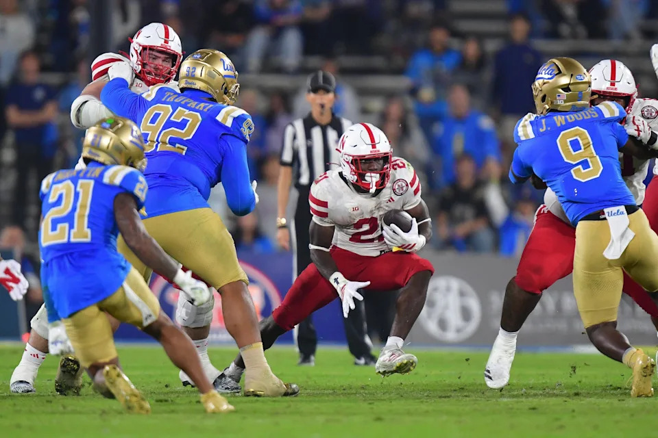 Nov 8, 2025; Pasadena, California, USA; Nebraska Cornhuskers running back Emmett Johnson (21) runs the ball against the UCLA Bruins during the second half at the Rose Bowl. Mandatory Credit: Gary A. Vasquez-Imagn Images