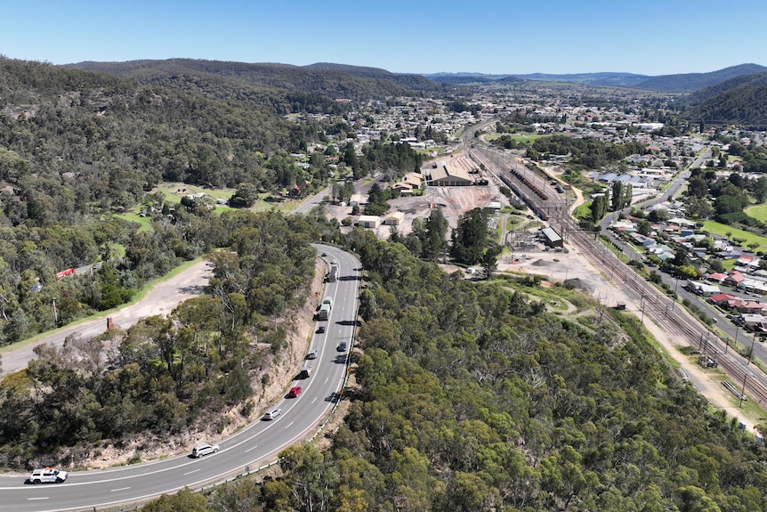 Drone image of Lithgow, with train line on right going through town, Bells Line of Road on left. 