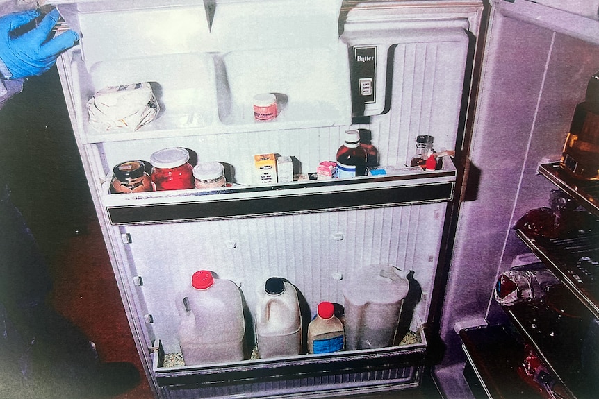 A fridge with many containers in it.