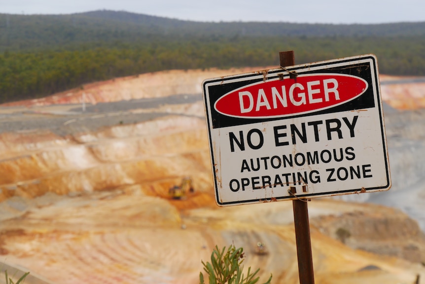 A sign reads 'no entry, autonomous operating zone' above the mining pit in Boddington.