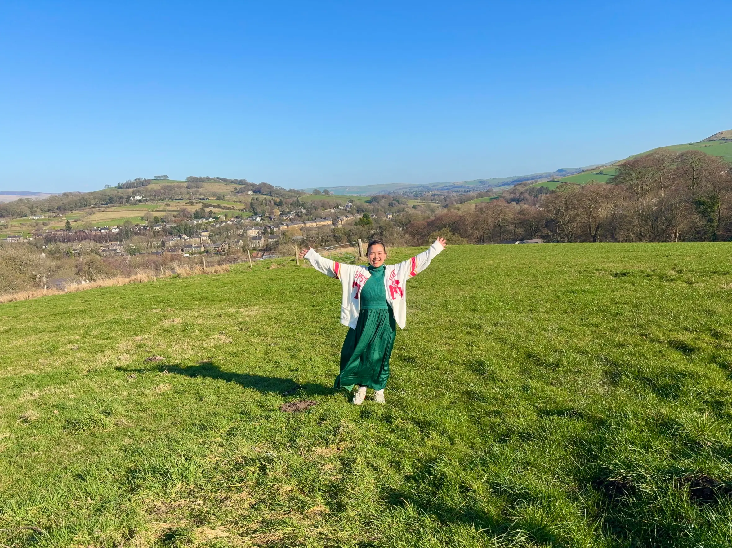 Sonoko Obuchi with her arms outstretched in a field in the countryside near Manchester.