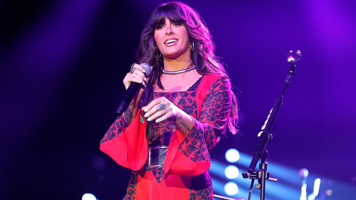Ella Langley on stage in a red shirt while performing at the Omni Nashville Hotel in March 2026.