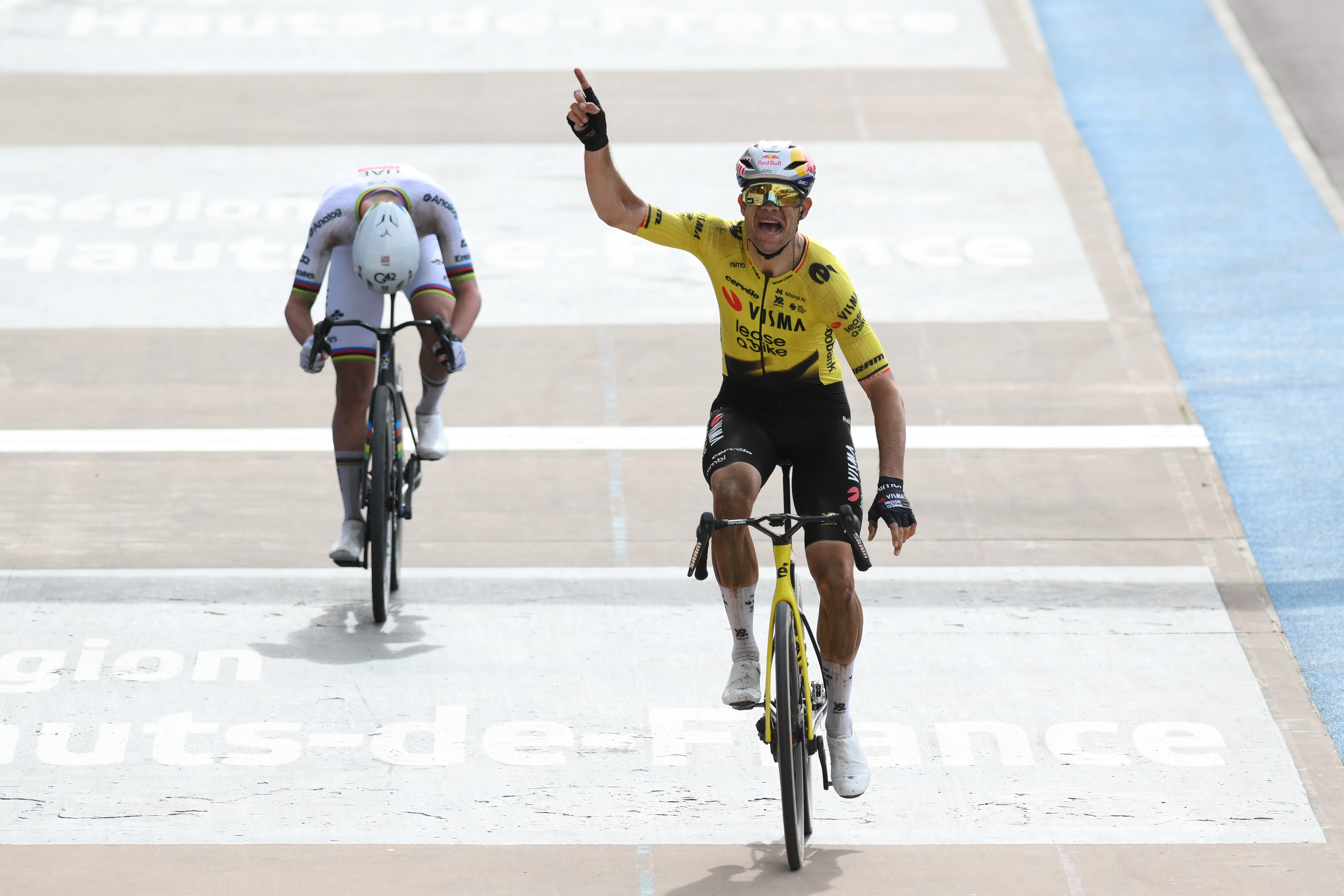 Wout van Aert celebrates as he crosses the finish line to win ahead of Tadej Pogacar during the 123rd men's Paris-Roubaix Hauts-de-France 2026