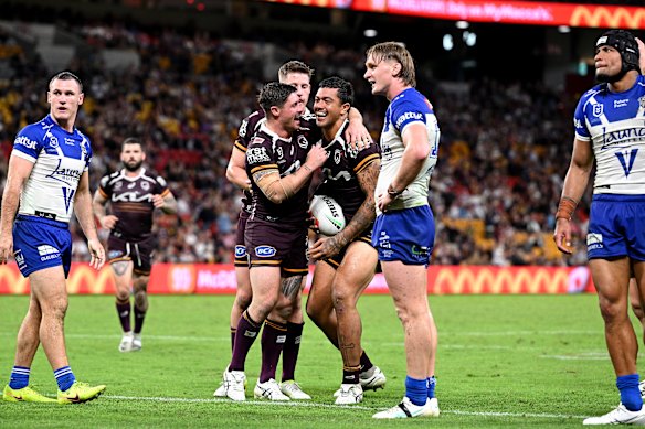 Xavier Willison of the Broncos celebrates with teammates after scoring a try against the Bulldogs at Suncorp Stadium.