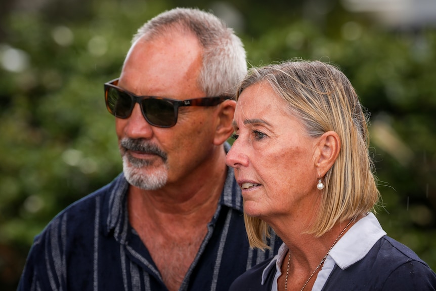 A man and woman stand side by side.
