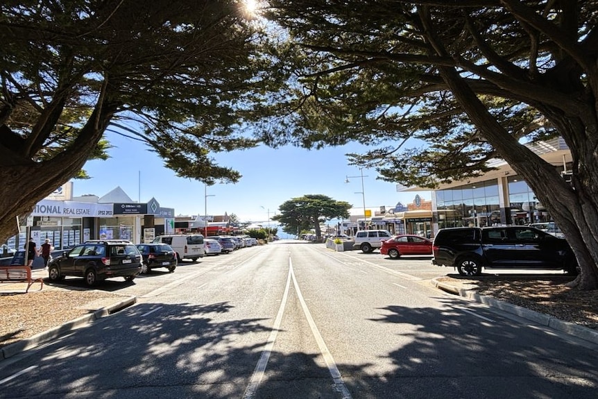 The main street of Cowes with commercial businesses and cars