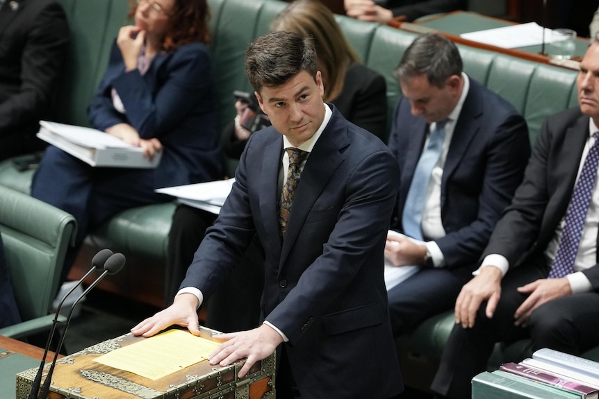 A man wearing a suit stands at the dispatch box in the House of Representatives.