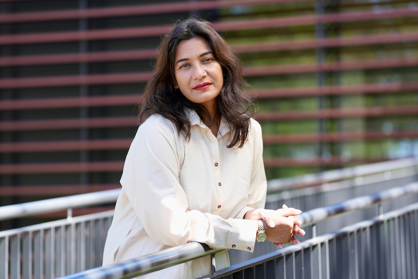 A professional outdoors with a sombre expression.