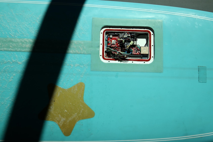 Wires embedded into blue surfboard