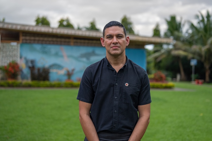 A man looks at the camera.