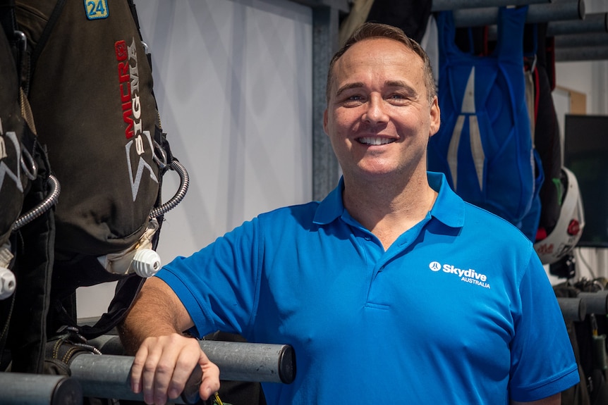 Paul Poulos in a casual shirt smiles for the camera