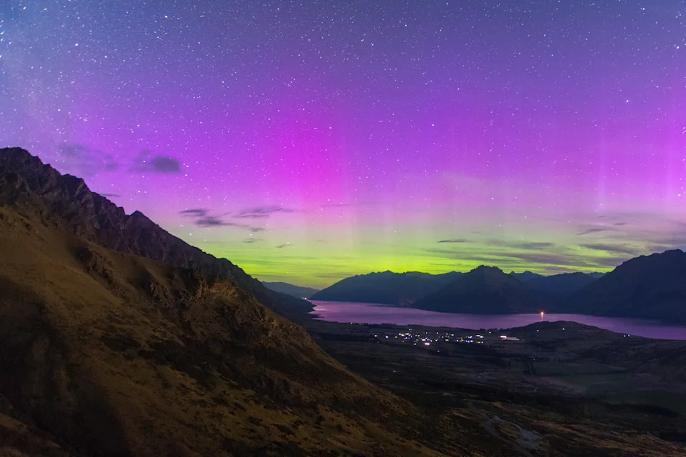 Southern light in New zealand with the view of river, mountain and city lights