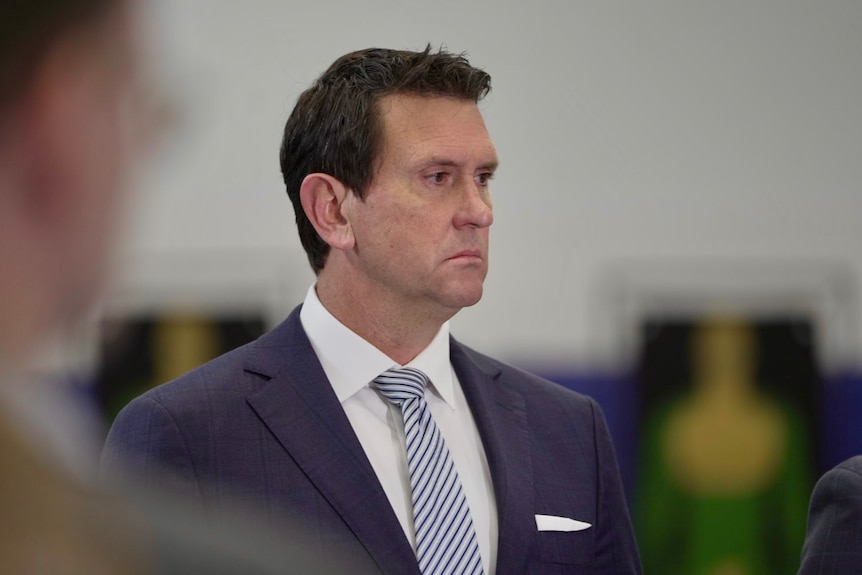 A man in a suit pictured in side profile.
