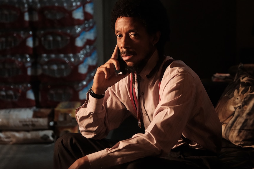 Darrell Britt-Gibson as Bishop sitting down with hand on side of face and under chin