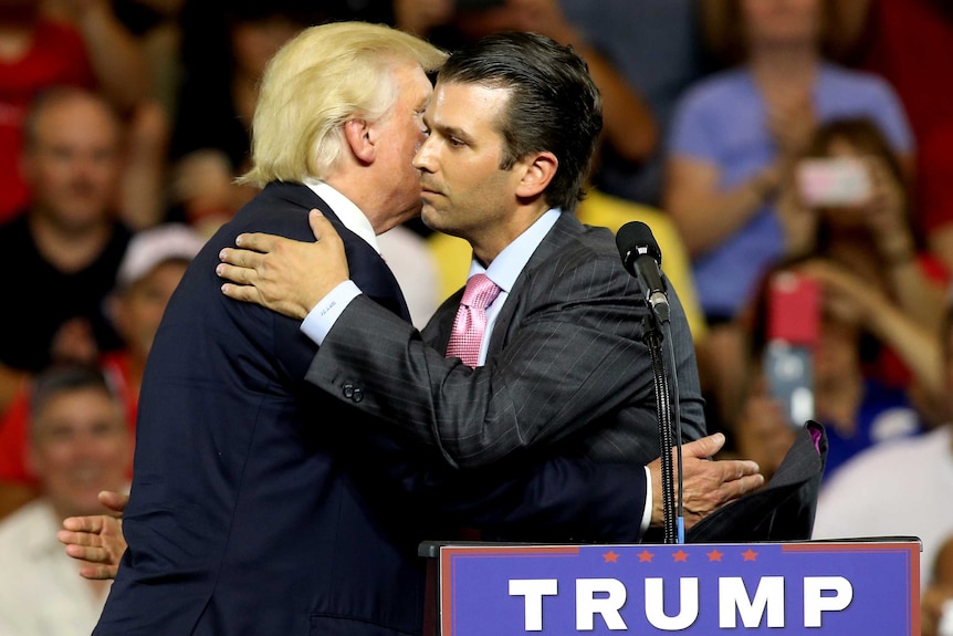 Donald Trump hugs his son Donald Trump Jr at a campaign rally.
