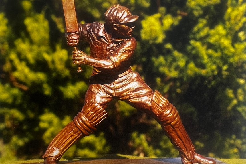 Bronze maquette statue in outdoor setting showing the cricketer batting