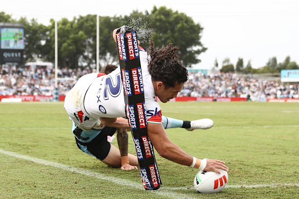 Dallin Watene-Zelezniak scores his third try against the Sharks.