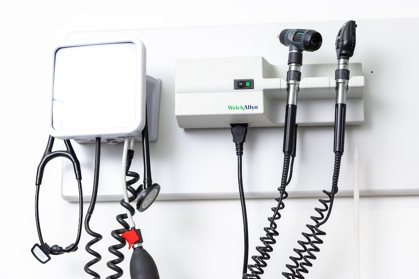 Doctor's equipment hanging on the wall inside a medical consultation room.