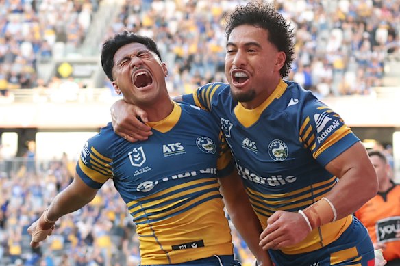 Eels fullback Joash Papalii (left) celebrates a try on Sunday.