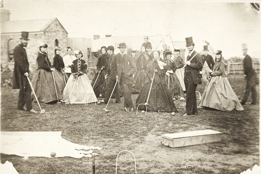 Black and white photograph from 1868 showing men and women in period dress playing croquet in regional SA