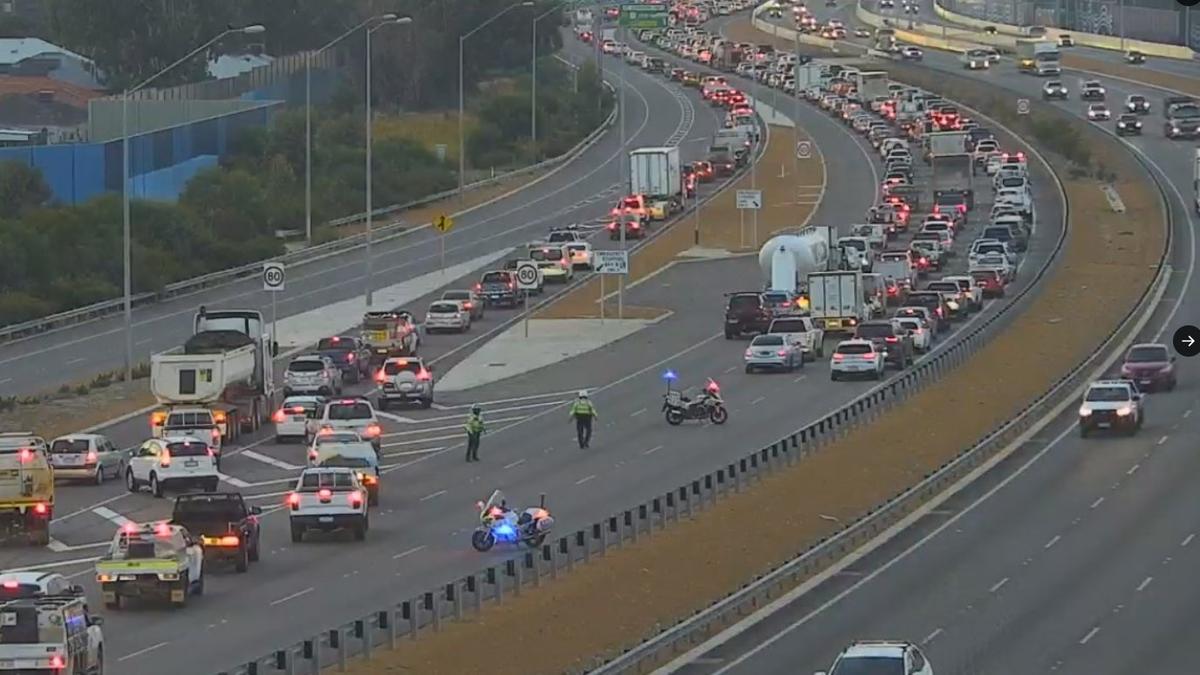 Perth traffic: Motorbike rider fighting for life after getting trapped under car in Tonkin Highway crash