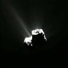 An animation of a comet rotating and releasing particles of dust