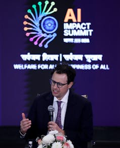Dario Amodei on stage at an AI summit.