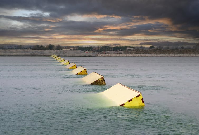 Steel barriers rising from the water