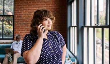 A woman on a phone call in a workspace.