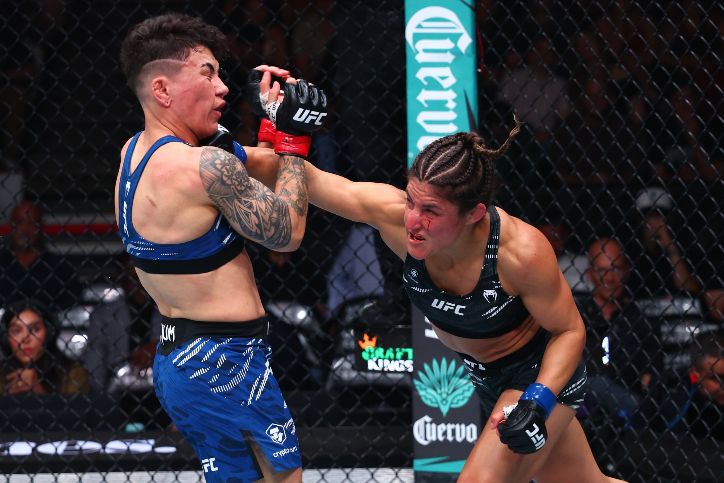 CHICAGO, ILLINOIS - AUGUST 16: (R-L) Loopy Godinez of Mexico punches Jessica Andrade of Brazil in a strawweight fight during the UFC 319 event at the United Center on August 16, 2025 in Chicago, Illinois. (Photo by Ed Mulholland/Zuffa LLC)