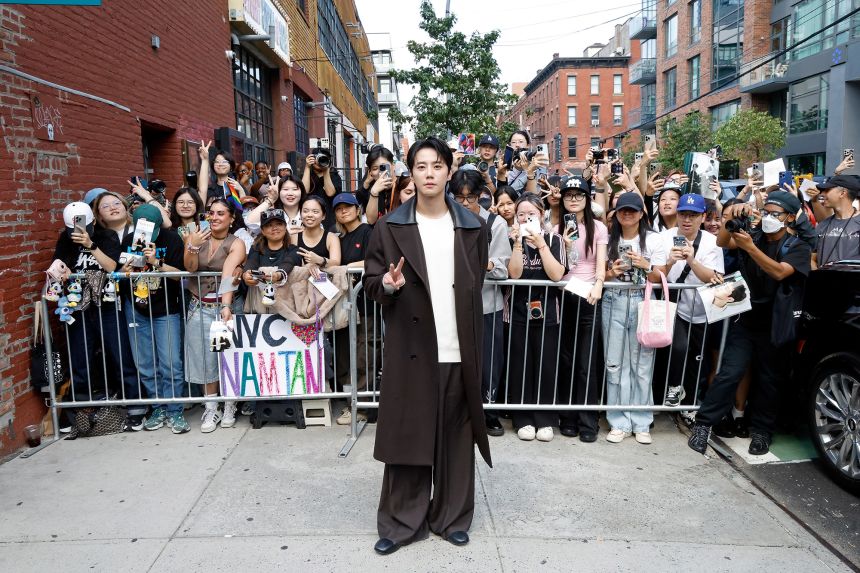 Jun of the South Korean boy band, Seventeen, poses with fans at the A/W 2025 COS fashion show during New York Fashion Week in Brooklyn, New York City, September 14, 2025.