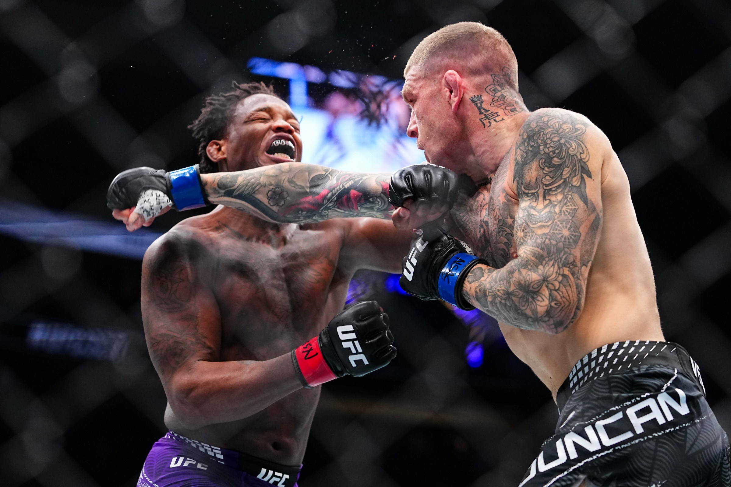 LAS VEGAS, NEVADA - DECEMBER 06: (R-L) Chris Duncan of Scotland punches Terrance McKinney in a lightweight fight during the UFC 323 event at T-Mobile Arena on December 06, 2025 in Las Vegas, Nevada. (Photo by Chris Unger/Zuffa LLC)