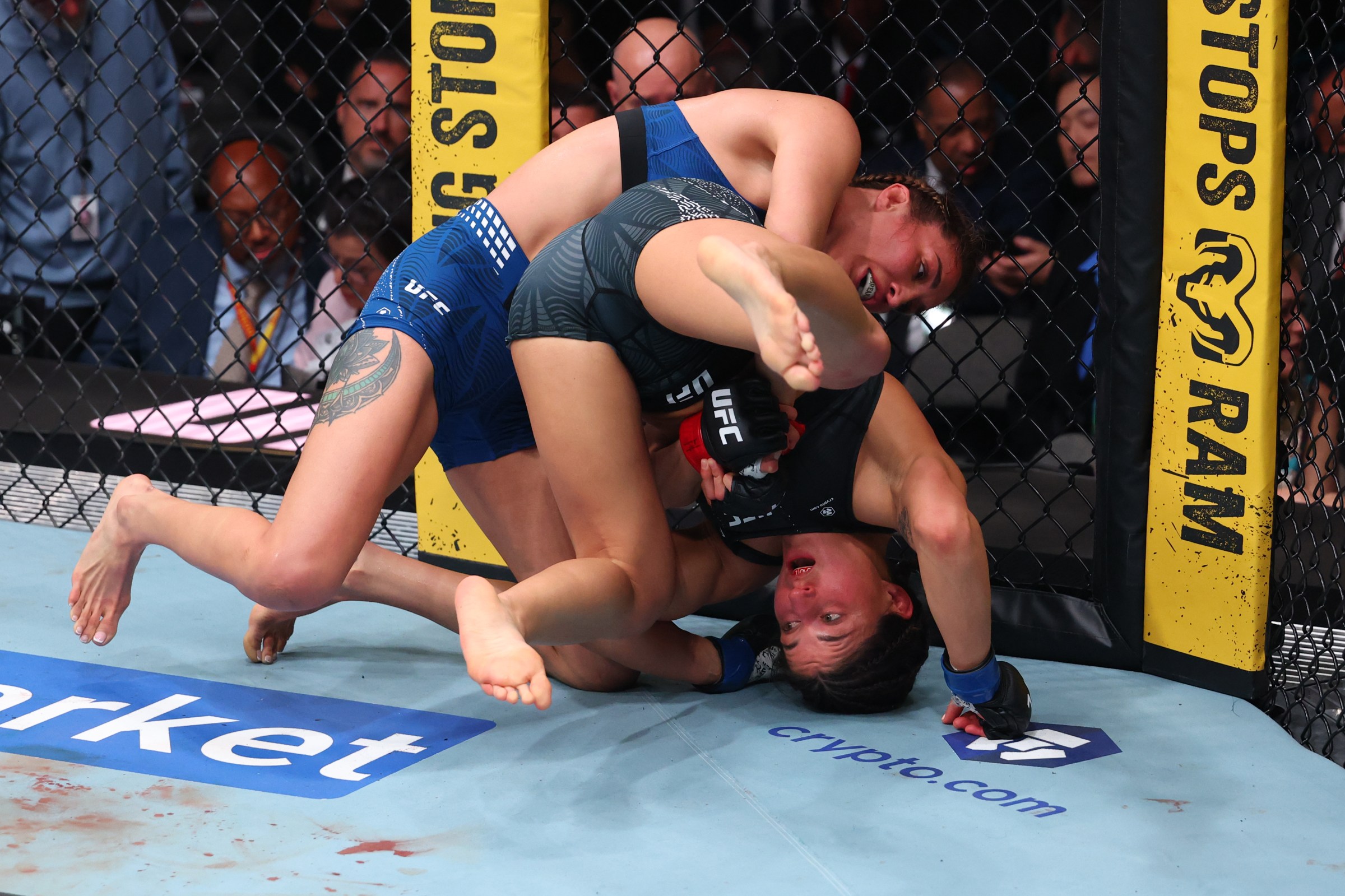 MIAMI, FLORIDA - APRIL 11: (L-R) Tatiana Suarez takes down Loopy Godinez of Mexico in a strawweight fight during the UFC 327 event at Kaseya Center on April 11, 2026 in Miami, Florida. (Photo by Ed Mulholland/Zuffa LLC)