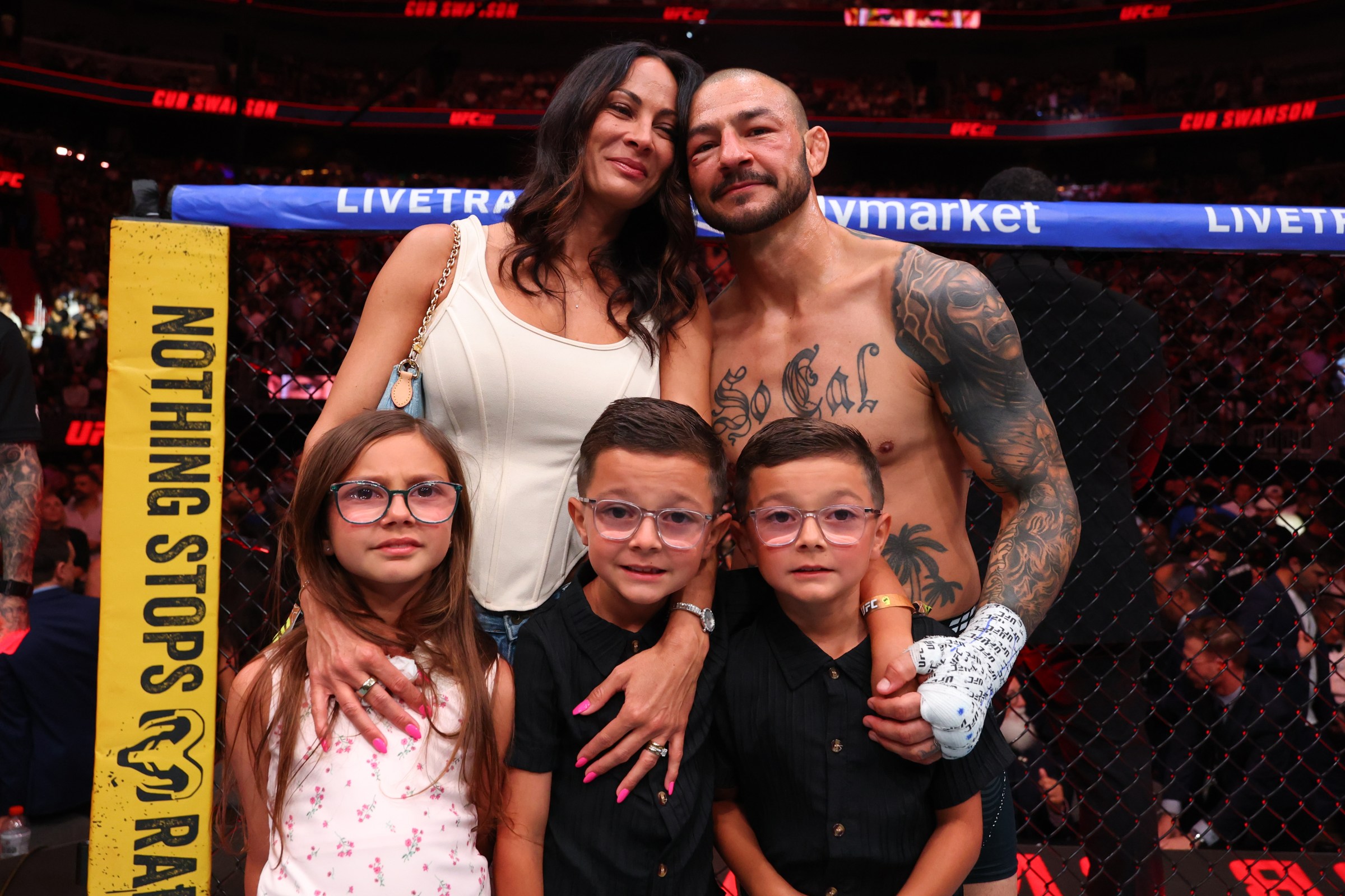 MIAMI, FLORIDA - APRIL 11: Cub Swanson celebrates with his wife, Kenda, and children Royal, Saint, and King, after his retirement fight during the UFC 327 event at Kaseya Center on April 11, 2026 in Miami, Florida. (Photo by Ed Mulholland/Zuffa LLC)