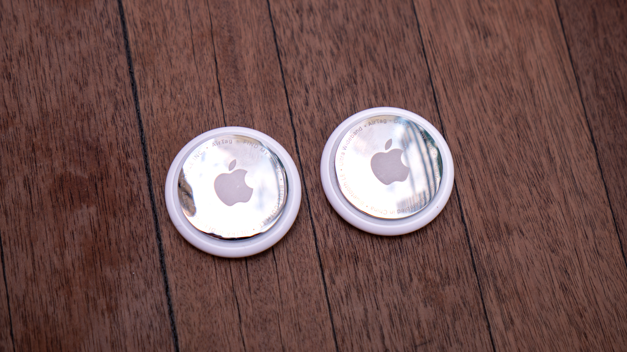 Apple AirTag 2 held in the hand.