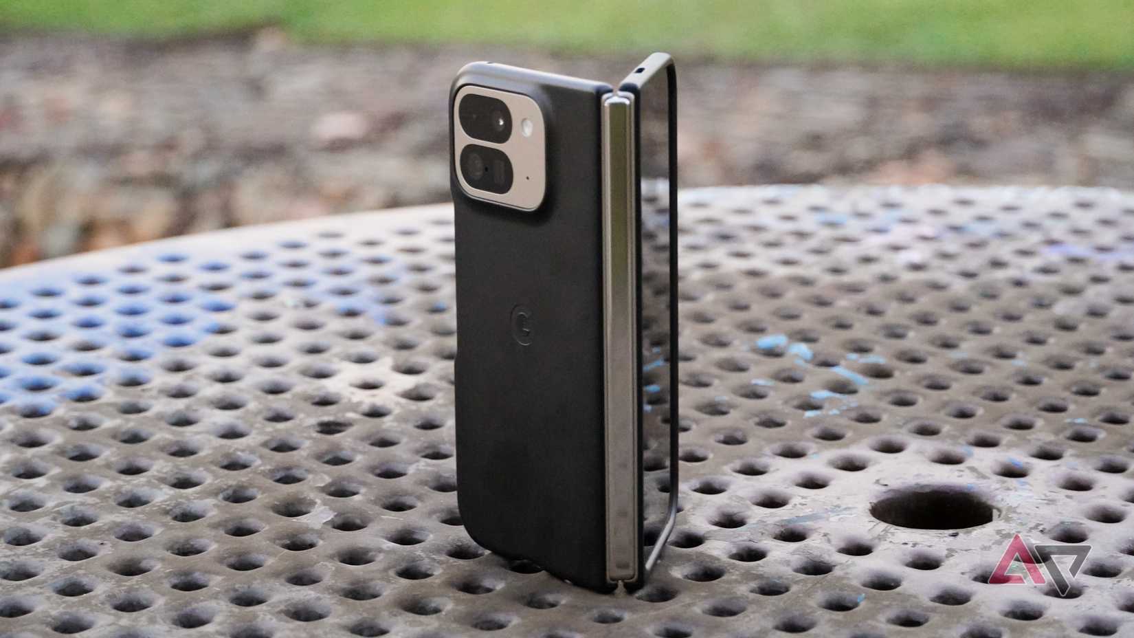 An angled view of the Pixel 9 Pro Fold wearing the official Google case half-opened.