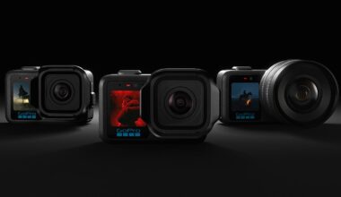 Four GoPro cameras are arranged side by side on a dark surface, each displaying different action scenes on their small front screens. The background is dark, highlighting the cameras.