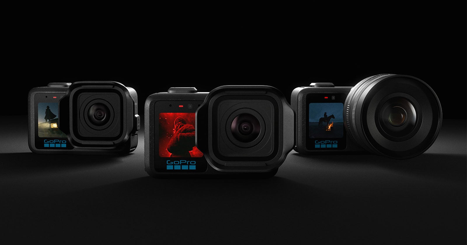 Four GoPro cameras are arranged side by side on a dark surface, each displaying different action scenes on their small front screens. The background is dark, highlighting the cameras.