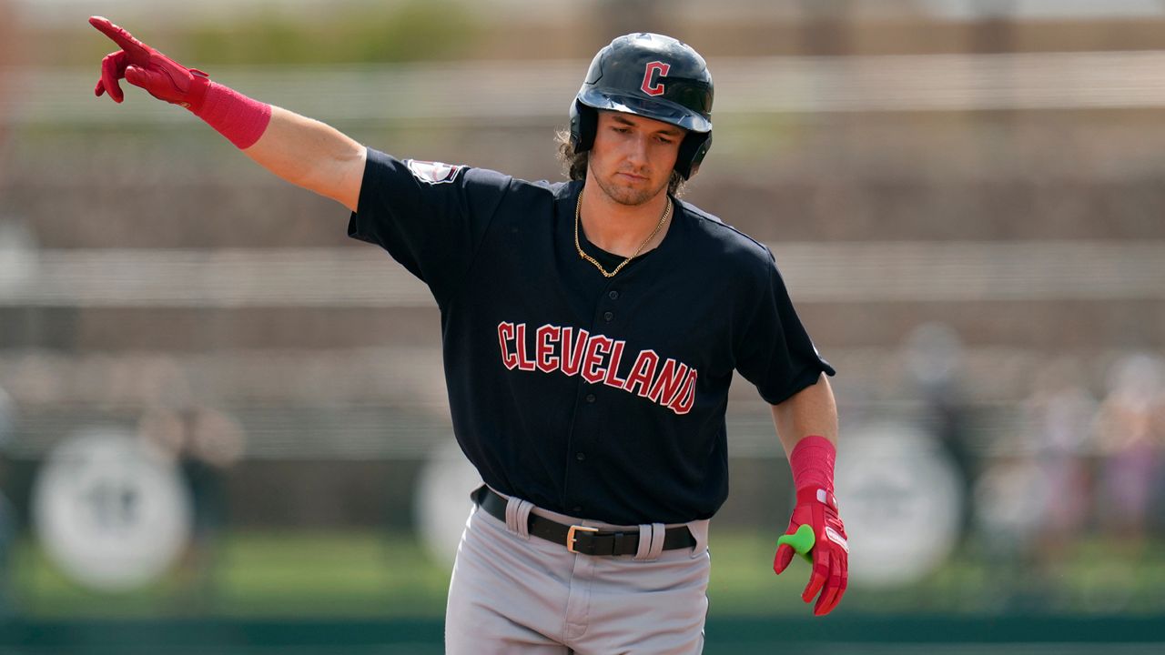 Cleveland Guardians' Chase DeLauter points as he rounds the bases after hitting a three-run home run against the Chicago White Sox during the first inning of a spring training baseball game, March 18, 2024, in Phoenix.