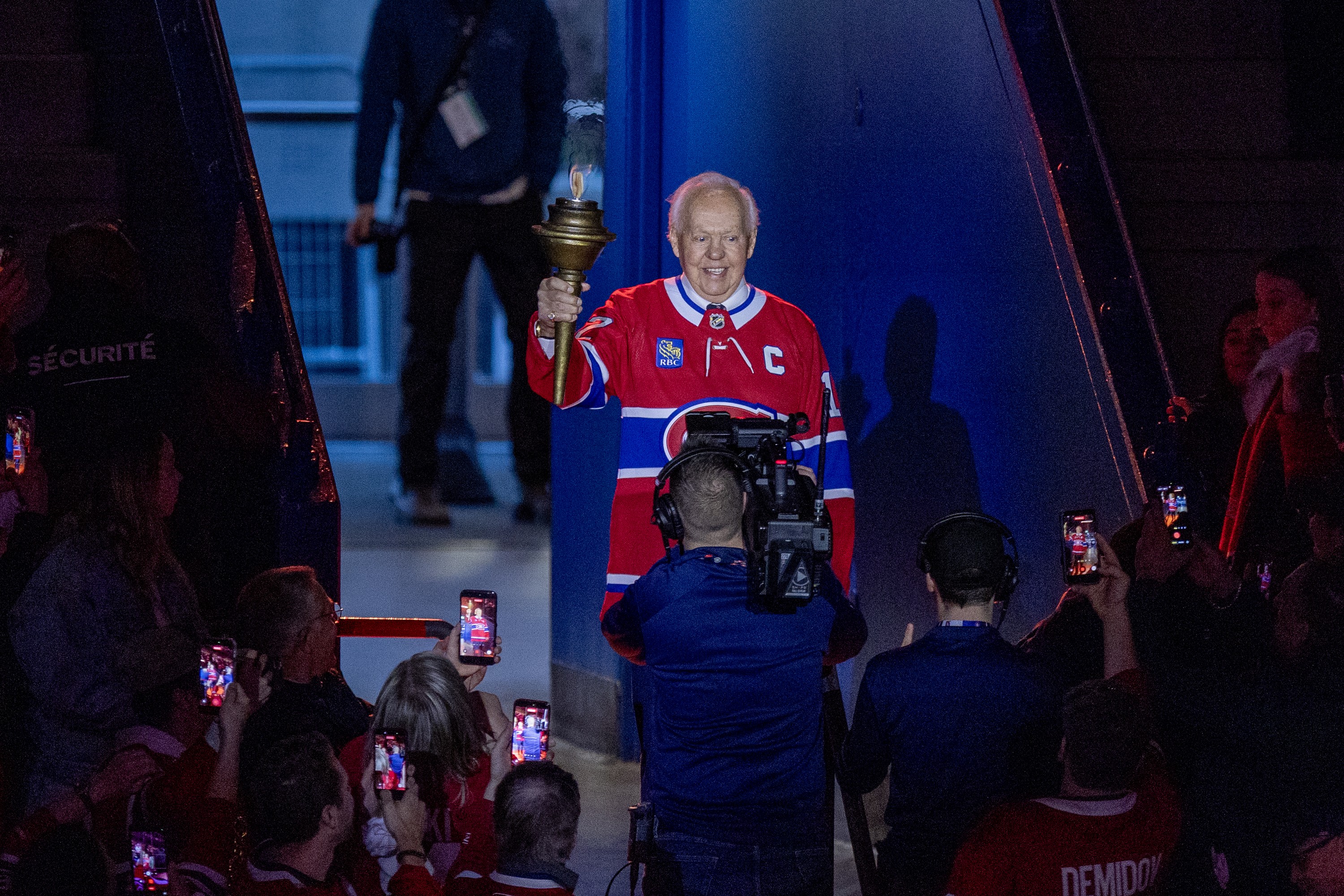 Montreal Canadiens Hall of Famer Yvan Cournoyer carries torch