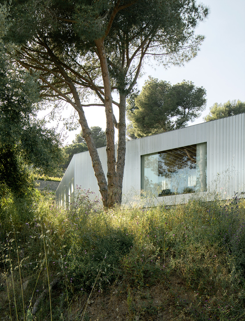 metallic house 144º rises on steel stilts above hillside near barcelona - 3