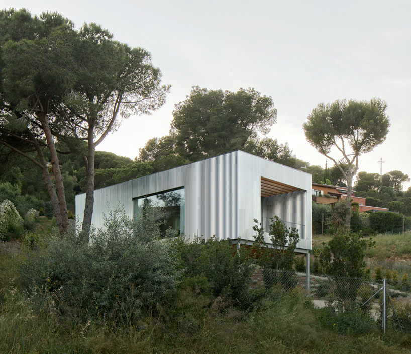 metallic house 144º rises on steel stilts above hillside near barcelona - 2