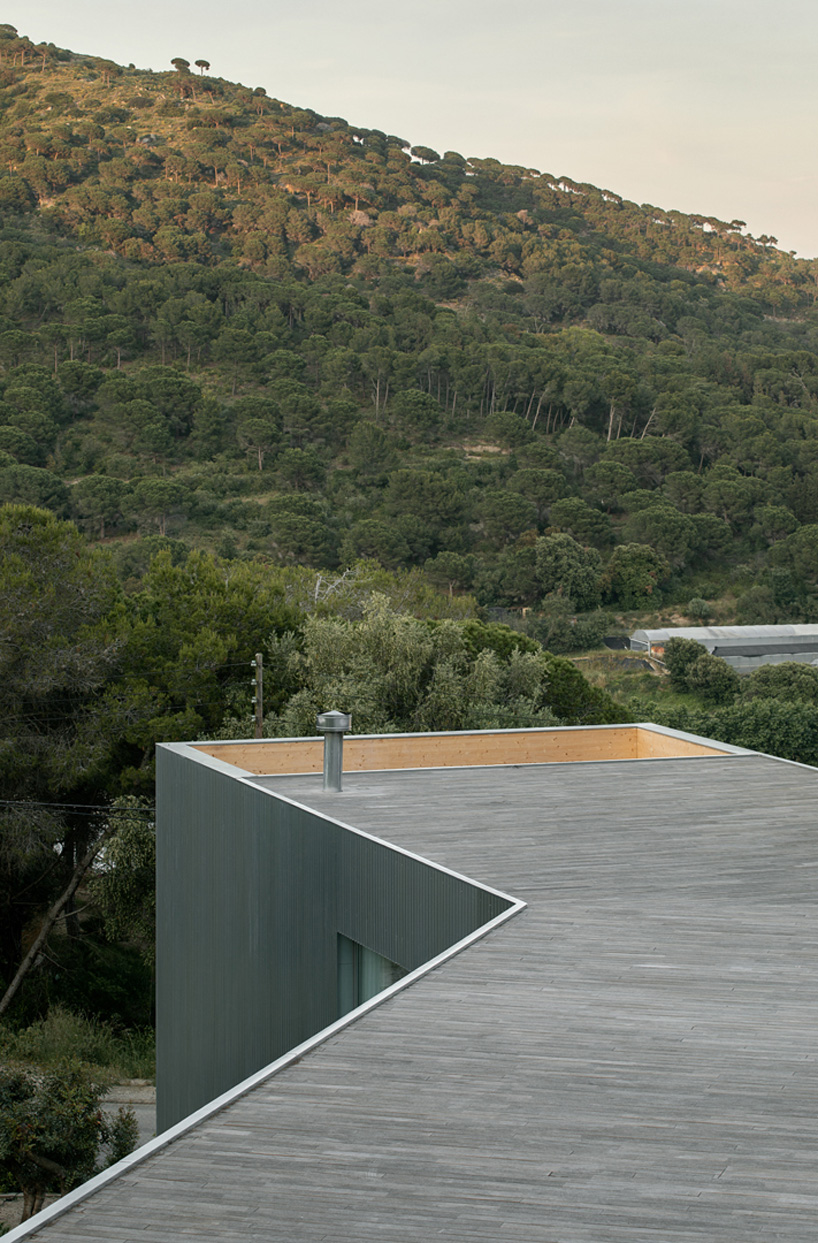 metallic house 144º rises on steel stilts above hillside near barcelona - 6